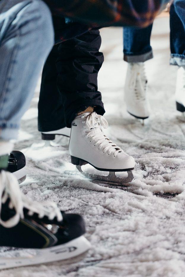 This is an image of ice skates on a snowy patch of ice.