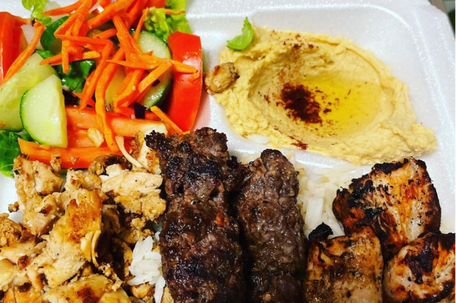 This is an image of the Mixed Grill plate: chicken shawarma, kafta kabob, and chicken kabob.