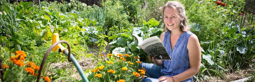 Emma Schneider reading in garden