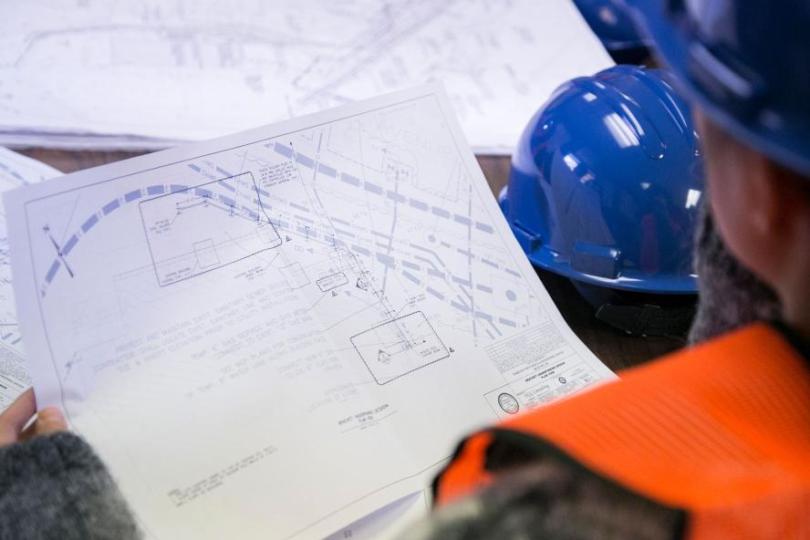 An engineer reviews construction plans