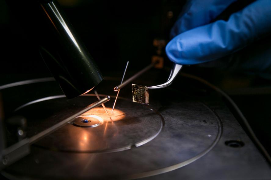 A solar panel chip is examined in the lab