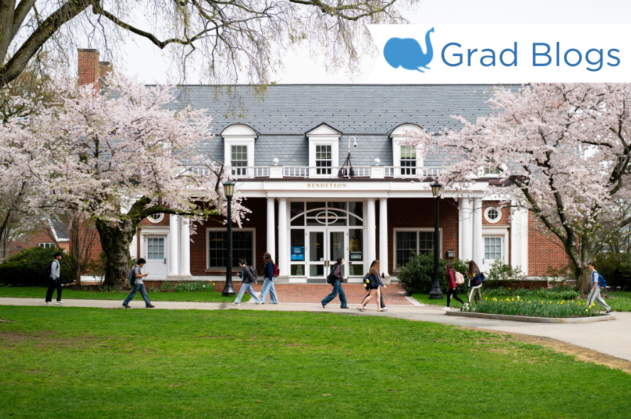 Students walk in front of Bendetson Hall on a cloudy day