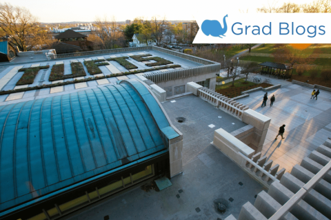 Image of the roof of Tisch Library with students walking on campus
