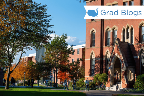 Image of building on Tufts campus, students walking in the background