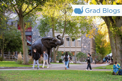 Image of students walking on Tufts' Medford campus in front of the Jumbo the Elephant statue